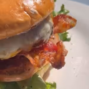 juicy cheeseburger with bacon, lettuce and tomato